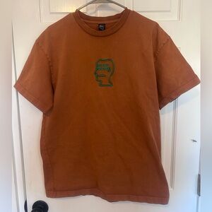 Brain Dead Rust Tee with Green Embroidered Graphic